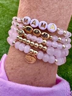 Celebrate Mom with personalized Mama stacking bracelets! Made with rose quartz gemstone beads, 14k gold filled accents, and gold charm on durable stretch elastic. You choose the bracelet style(s) and custom name personalization (Mom, Mama, Mommy, custom name). These bracelets can be worn separately or stacked together.  The perfect gift for new moms, gift for Mother's Day, Birthdays and a baby shower. Rose quartz is the stone of unconditional love. Please add each bracelet style separately to yo Pink Letter Beads Bracelets As Gift For Mom, Gift Rose Quartz Beaded Bracelets In Gold, Gold Rose Quartz Beaded Bracelets As Gift, Pink Stackable Stretch Bracelet For Mother's Day, Pink Beaded Bracelet Gift For Mom With Round Beads, Pink Beaded Bracelet Gift For Mom, Pink Beaded Bracelets Round Beads Gift For Mom, Pink Round Beaded Bracelet Gift For Mom, Pink Stackable Jewelry For Mother's Day