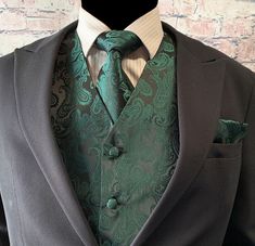 a man wearing a suit and tie with a green paisley print on the lapel