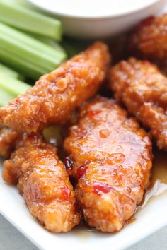 chicken wings with sauce and celery on a plate