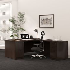 an office cubicle with a desk, chair and plant in the corner next to it