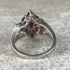 Garnet Cluster Ring Sz 7/Sterling Silver/Genuine 5.4ct Marquise Cut/Rhodolite Garnet/Signed/Pink Purple Garnet/Vintage Estate/Ring For Women Description Beautiful rhodolite garnet ring in excellent vintage condition. A total of 5.4ct of genuine, marquise cut garnet set in designer signed stamped 925 sterling silver setting. Face of ring measures 20mm from top to bottom and has a weight of 5.1g. Gorgeous pink purple color and fantastic sparkle! Size 7. All Gems tested with Presidium Gem Tester. A Silver Marquise Multi-stone Diamond Ring, Silver Marquise Ruby Ring For Anniversary, Silver Multi-stone Cluster Ring, Fine Jewelry Marquise Ruby Ring With Multi-stone, Marquise Multi-stone Ruby Ring, Marquise Multi-stone Ruby Ring In Fine Jewelry Style, Silver Pear-shaped Ruby Ring, Silver Cluster Emerald Ring, Silver Cluster Emerald Gemstone Ring