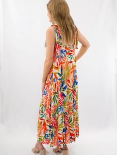 The perfect resort dress exists. Our bright palm leaf maxi dress features tie shoulders and a ruffle hemline. We love a bright pallet for summer! SIZE & FIT Fit is true to size Model is 5'6" wearing size small Green Tiered Sundress For Vacation, Green Tropical Sundress, Tropical Multicolor Sundress With Tropical Print, Tropical Multicolor Sundress For Vacation, Tropical Sundress For Beach Party, Vibrant Green Tropical Print Maxi Dress, Tropical Print Sundress For Vacation, Tropical Sundress With Tropical Print For Vacation, Summer Tiered Dress With Tropical Print