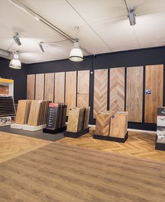 the interior of a building with wood flooring and various types of tile on display