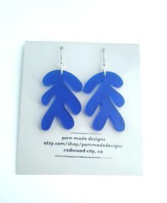 Dark blue cobalt plastic earrings in the style of Matisse.  Titanium ear wires. Earrings are translucent. Designed by me using inkscape software, and cut on a glowforge laser cutter. Blue Enamel Earrings With Artistic Design, Blue Modernist Jewelry With Polished Finish, Blue Hypoallergenic Glass Earrings, Artistic Hand-painted Blue Earrings, Cobalt Blue Earrings, Plastic Earrings, Make Design, Blue Earrings, Cobalt Blue