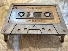 an old fashioned metal cassette player sitting on top of a white bed sheet with the words, the good life lynx's mix written on it