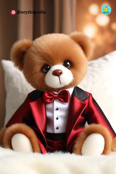 a brown teddy bear wearing a red suit and bow tie sitting on a white bed