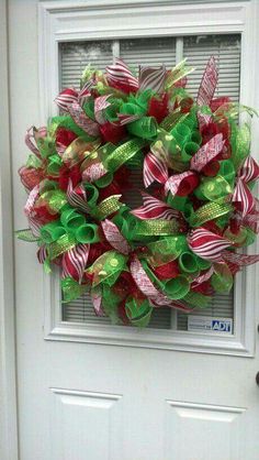 a christmas wreath is hanging on the front door