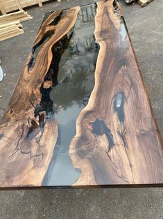 the table is made out of wood and has black paint on it's surface