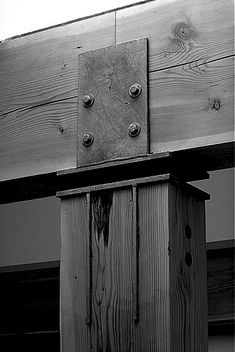 a wooden structure with metal brackets on it