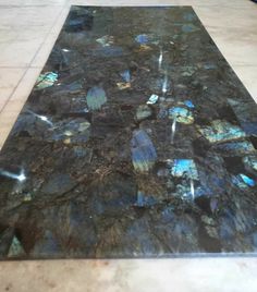 a marble floor with blue and black tiles on it