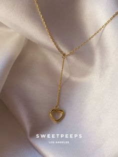 Product Details + Care  - 18K Gold Dipped Over Brass - Brass: Copper + Zinc Alloy - 1 Necklace - Wipe Clean  - Imported  Dimensions - Chain Approximately 16" Have a question? Please message info@shopsweetpeeps.com and our support team will get back to you in 48 hours. Adjustable Gold Plated Heart Necklace, Adjustable Heart-shaped Gold Plated Necklace, Adjustable Heart-shaped Gold-plated Necklace, Adjustable Gold-plated Heart Necklace, Dainty Dangle Charm Necklaces For Valentine's Day, Dainty Valentine's Day Dangle Charm Necklaces, Dainty Valentine's Day Charm Necklace With Dangle, Gold Heart Dangle Necklace With Adjustable Chain, Adjustable Gold Heart Necklace With Clavicle Chain