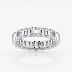 a white gold ring with baguetts and diamonds on the side, set in 18k white gold