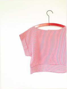 Fab 1990s candy striped Top with back button fastening and a wide boat style neckline. Cropped boxy style with turned up sleeves. Available on layaway, Please DM us for details. Measurements: - 15" Shoulder  - 36" Bust  - 33" Hem circumference - 16.5" Length Description: Vintage Blouse in Excellent Condition. There is no original label but we estimate the material to be cotton. How we measure our garments: * Shoulders - Measured flat between arm hole seams across shoulders * Bust - Measured flat