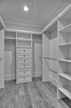 an empty walk in closet with shelves and drawers