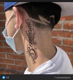 the back of a man's neck has a tattoo on it that reads,