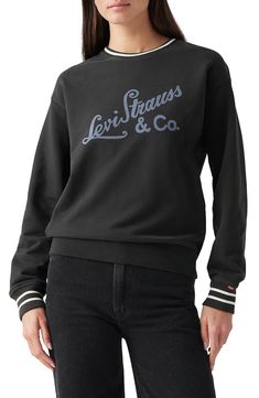 Striped trim amplifies the sporty appeal of a slouchy crewneck sweatshirt showcasing a retro logo print. Crewneck 100% cotton Machine wash, tumble dry Imported Fall Long Sleeve Sweatshirt With Logo Lettering, Black Long Sleeve Sweatshirt With Logo Lettering, Black Long Sleeve Sweatshirt With Logo, Black Top With Logo Lettering For Winter, Black Tops With Logo Lettering For Winter, Black Logo Lettering Top For Winter, Casual Black Sweatshirt With Logo Lettering, Black Logo Sweatshirt For Fall, Crew Neck Sweatshirt With Logo For Fall