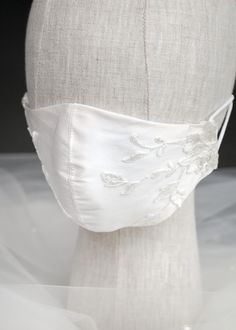 a white mannequin headpiece on top of a dressmaker's dummy