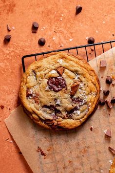 a chocolate chip cookie sitting on top of a piece of paper