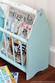 a blue magazine rack with magazines on it