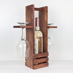 a wine glass holder with two wine glasses on it and a bottle in the bottom