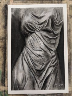 a black and white drawing of a woman's torso with draped fabric on it