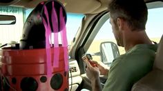 a man sitting in the back seat of a car holding a cell phone