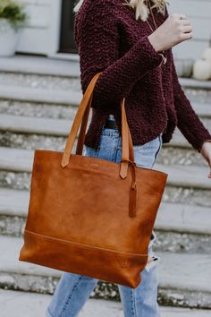 Beautiful. That’s what you call this large saddle tan leather tote bag. The large size is just right, whether you’re carrying a laptop or your favorite pen and journal. The full grain leather with minimalistic design is lightweight for its size. The handmade stitching details make it a fun addition to any outfit — for travel, work, or play. Leather Tote Bag Outfit, Handbag Inspiration, Buffalo Jackson, Leather Working Projects, Leather Tote Handbags, Tan Leather Tote, Diy Leather Bag, Leather Tote Bags, Diy Bags