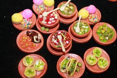 there are many small bowls with candies in them