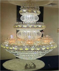 a very large chandelier with many lights on it's sides in a room