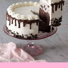 a cake with white frosting and chocolate toppings