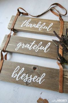 three wooden signs that say grateful, grateful and grateful with brown ribbons hanging from them