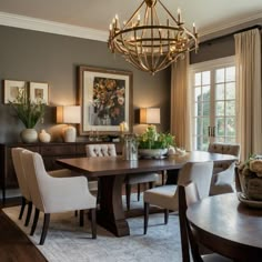 a dining room table with chairs and a chandelier