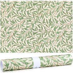 a roll of wrapping paper with green leaves on it and the bottom half rolled up