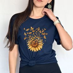 Sunflower Butterfly Shirt, Floral Shirt, Flower Shirt, Wildflower Shirt, Garden Shirt, Women Fall Shirt, Sunflower T-Shirt, Sunshine Tee *ABOUT OUR TEES QUALITY -Our products are Bella Canvas and Gildan Soft Style. -Printed by our professional printing machine.  *Bella Canvas Features -unisex size -4,2 oz.    -Solid colors are 100% Combed and Ring-Spun Cotton -Athletic Heather 90% Combed and Ring-Spun Cotton, 10% Polyester -All Heather CVC Colors 52% Combed and Ring-Spun, 48% Polyester *Gildan S Blue Butterfly Print T-shirt For Summer, Blue Butterfly Print T-shirt For Spring, Blue Butterfly Print Short Sleeve T-shirt, Blue Short Sleeve T-shirt With Butterfly Print, Summer Cotton Shirt With Butterfly Print, Multicolor Sunflower Print Top For Summer, Blue Floral Print Crew Neck Shirt, Casual Short Sleeve Butterfly Print Shirt, Casual Butterfly Print Short Sleeve Shirt