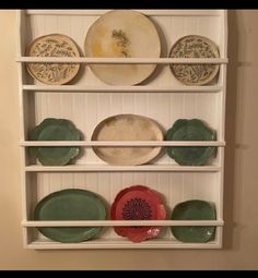 a shelf with plates and bowls on it