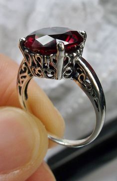 "Garnet CZ Ring K Ring Design#4 Custom Made This is a brand new Victorian design in solid sterling silver. The beautiful trellis filigree of the ring is amazing vintage style. This full cut sparkling CZ gemstone is 12mm ( approximately 1/2\") in diameter. The inside of the band is marked 925 for sterling silver. It is a ring that will be treasured as an heirloom. Notice the beautifully intricate design of the silver filigree setting and trellis band. This alluring ring has beautiful shine and lu Classic Style Jewelry, Classic Solitaire Ring, Red Garnet Ring, Edwardian Jewelry, Filigree Jewelry, Garnet Ring, Sterling Silver Filigree, Filigree Ring, Cz Ring