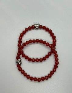 Handmade red carnelian gemstone bracelet with a silver heart bead. I love how deep the red of these beads are. It is perfect for love. These bracelets make a wonderful, unique anniversary gift or Valentine's Day gift. Your wife, girlfriend, partner etc can wear your love with them. I have both a regular woman's size bracelet and a men's size bracelet. They are adorable together as a matching jewelry set. You can each wear each other's love. I find these traditional silver heart charms perfect fo Red Bracelet, Unique Anniversary Gifts, Red Carnelian, Bracelet Heart, Red Gift, Red Bracelets, Matching Jewelry, Girlfriend Gift, Anniversary Gift For Her