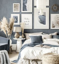 a bedroom with blue walls and pictures on the wall above the bed, along with wicker baskets