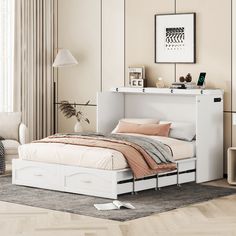 a white bed sitting in a bedroom next to a wall mounted shelf with pictures on it