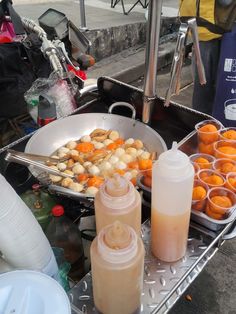 food is being prepared on a silver tray with utensils and containers next to it