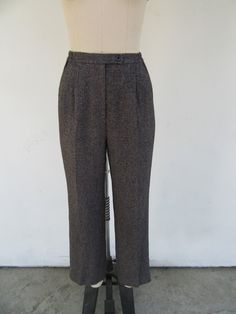 90s heathered charcoal high waisted plated trousers. Presumed wool--no labels present. Fully lined. Partially elasticized waist. They have some subtle pinstriping that runs both vertically as well as horizontally that makes for a very subtle checkered pattern. Pinstriping is in fuchsia, orange, and blue and is the sort of thing you will only really see in bright lighting. Side pockets. Maker unknown.  Label size not present, fit like S M  Please note somewhat slim hip measurement Please compare measurements to a similar garment that fits you well 25 to 28" waist 12" rise 38" hips 31" inseam Good vintage condition with minimal signs of use and age. Fitted Wool High Waist Bottoms, Fitted High Waist Wool Bottoms, Fitted Wool High-waisted Bottoms, Full Length Wool Bottoms For Fall, Vintage Trousers For Winter, Fitted High Waist Wool Pants, Vintage Wide Leg Pants For Winter, Vintage Winter Trousers, Vintage Full Length Bottoms For Winter