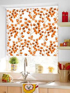 a kitchen window with orange flowers on it