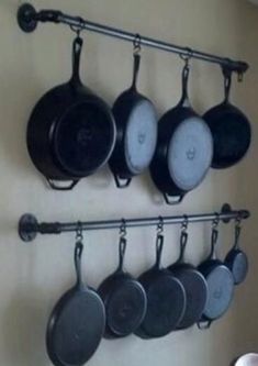 pots and pans are hanging on the wall