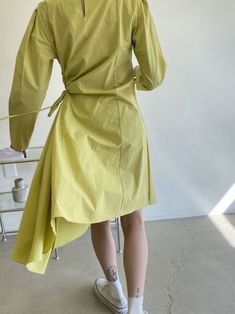 Cotton dress with long sleeves and shirred side waist with tie up. Rounded neckline, diagonal hemline and button details on sleeves. Model is wearing MINUSEY ONE SIZE. * MINUSEY ONE SIZE = EU 34-38, US 2-6* 100% Cotton* Dry clean* Made in Korea - Model Height: 170cm/5'7" (US2, EU34) Long Sleeve Midi Dress With Tie Fastening For Work, Long Sleeve Midi Dress With Tie Fastening For Summer, Long Sleeve Asymmetrical Dress For Spring Workwear, Long Sleeve Dress With Tie Fastening For Fall, Long Sleeve Fall Dresses With Tie Fastening, Fall Dress With Tie Fastening And Long Sleeves, Fall Long Sleeve Dress With Tie Fastening, Early Fall Outfits, Dress With Long Sleeves