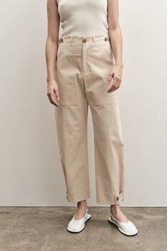 Mijeong Park cropped workwear trousers in light beige. Button and zipper fly front, two front patch pockets, one back patch pocket, adjustable waist and bottom with button and tap.50% cotton, 38% rayon, 7% polyester, 5% polyurethane. Model wears size small. Model is 5’10.” This style runs slightly large. If in between Workwear Style, Workwear Pants, Workwear Trousers, Leather Flip Flops, Secret Sale, Style Pants, Knit Tanks, Individual Style, Minimal Fashion