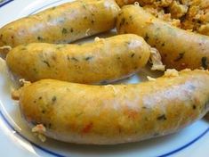 two sausages are on a plate with rice