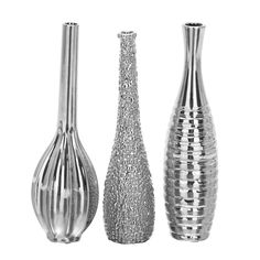 three silver vases sitting next to each other