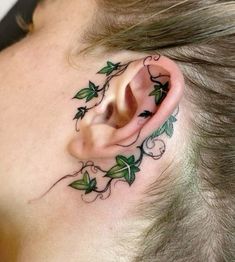 a close up of a person's ear with vines on it