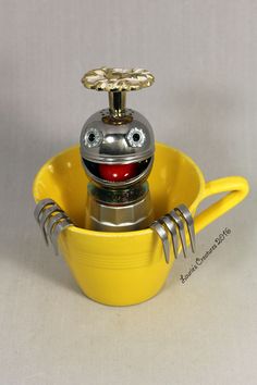 a yellow bowl with a metal object in it