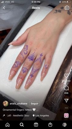 a woman's hand with tattoos on it